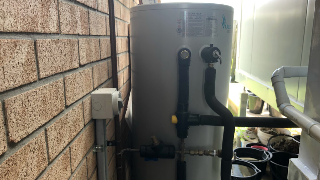 hot water system behind a granny-flat